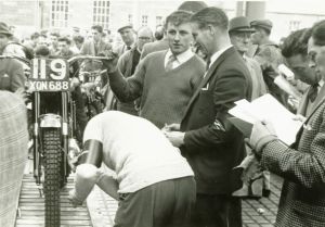 Arthur lampkin gets his 250 BSA 'weighed in' at the 1961 SSDT. Tommy Robertson is on second right examining paperwork